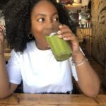 black girl drinking green smoothie