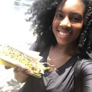Black girl with grilled corn