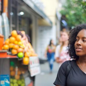 Black girl looking at fruit
