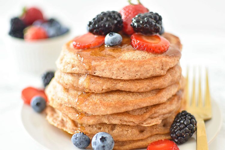 Stack of Whole Wheat Vegan Pancakes topped with fresh berries