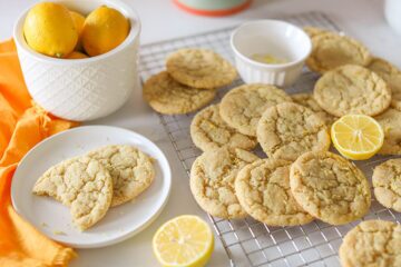 Vegan Lemon Sugar Cookies on a cooling rack and small white plate