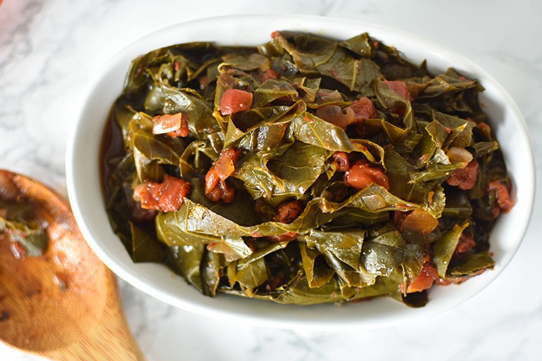 Slow Cooker Southern Collard Greens with Fire Roasted Tomatoes in white dish