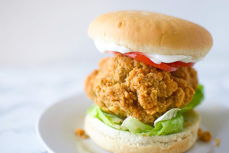Atlas Monroe Vegan Fried Chicken sandwich with lettuce, tomato and mayo