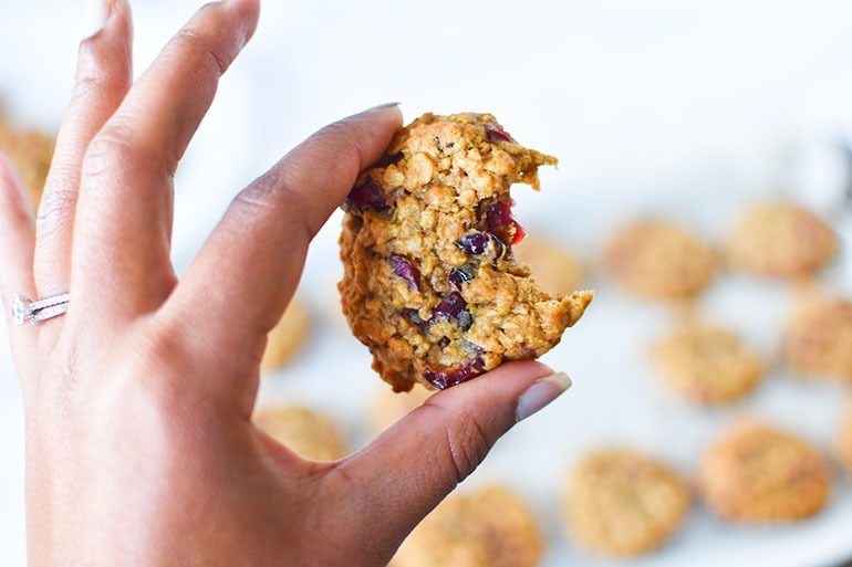 Vegan Cranberry Oatmeal Cookies with brown hand