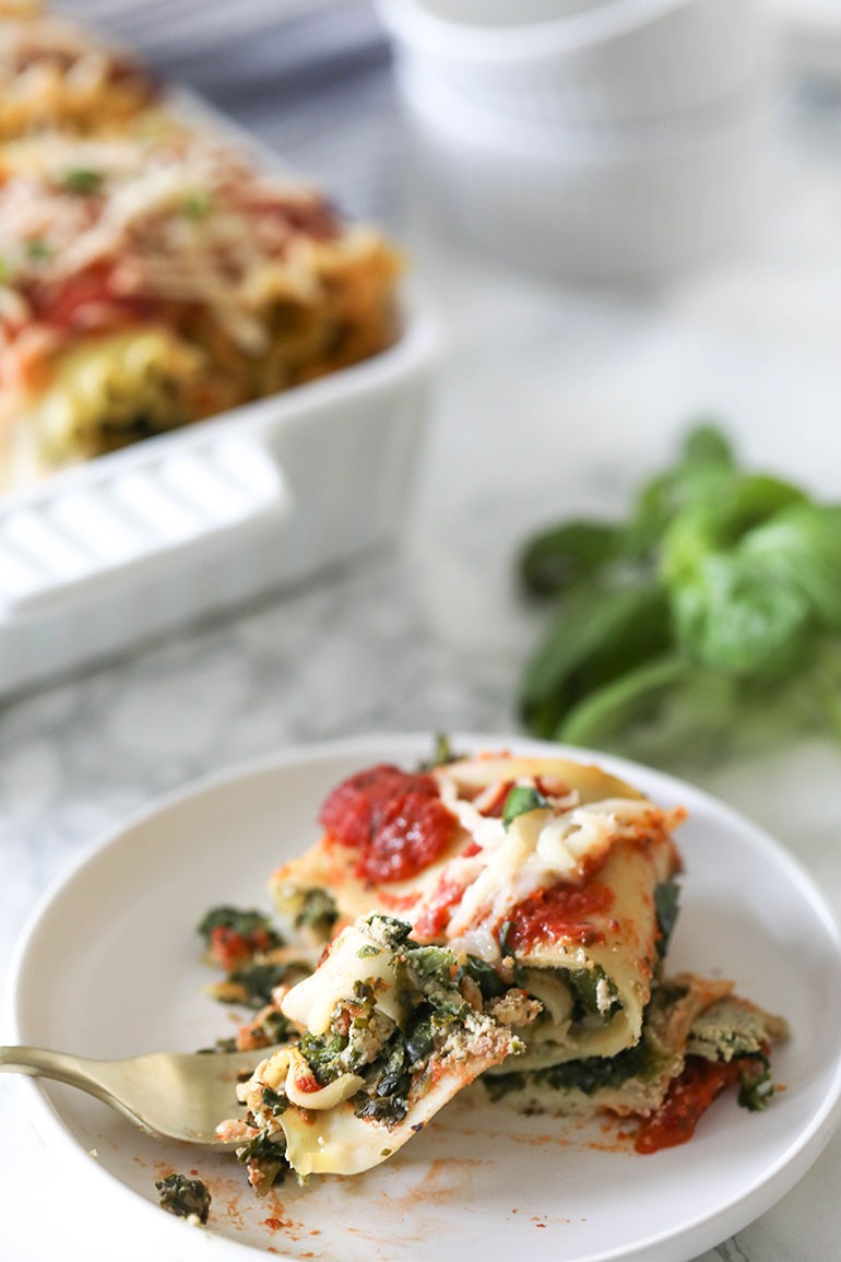 Vegan Spinach Lasagna Rolls with Almond Ricotta in white square baking dish