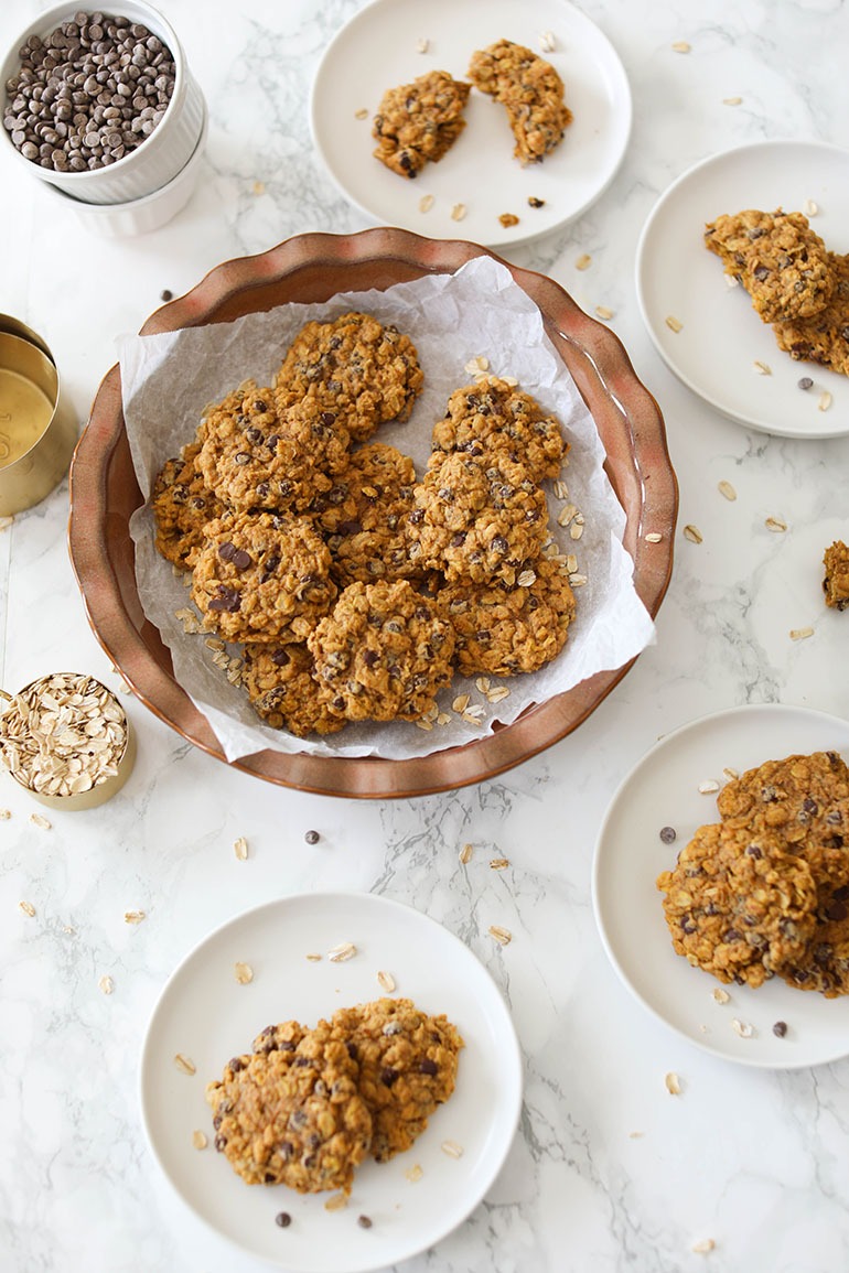 Vegan Pumpkin Chocolate Chip Oatmeal Cookies in round brown dish and white plates