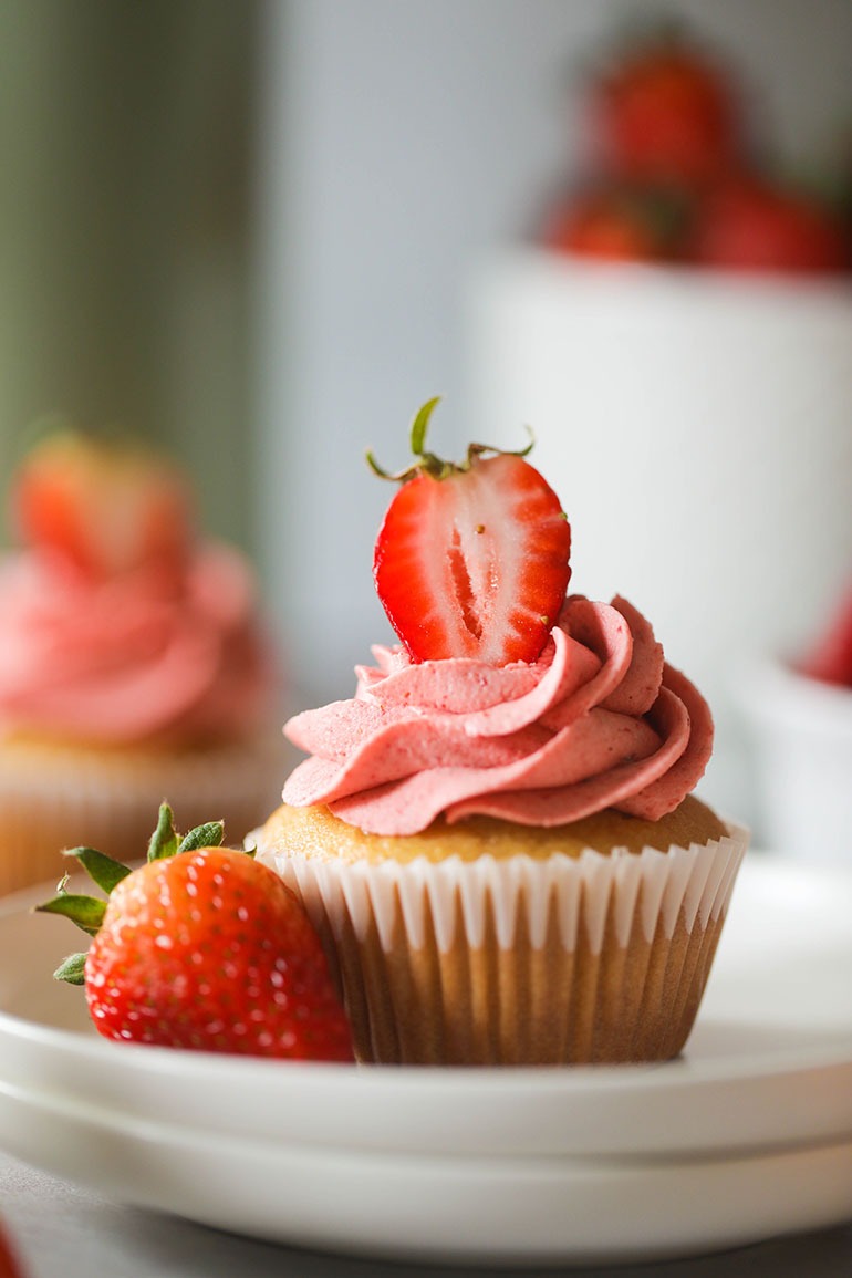 Vegan Strawberry Cupcake with fresh strawberry garnish