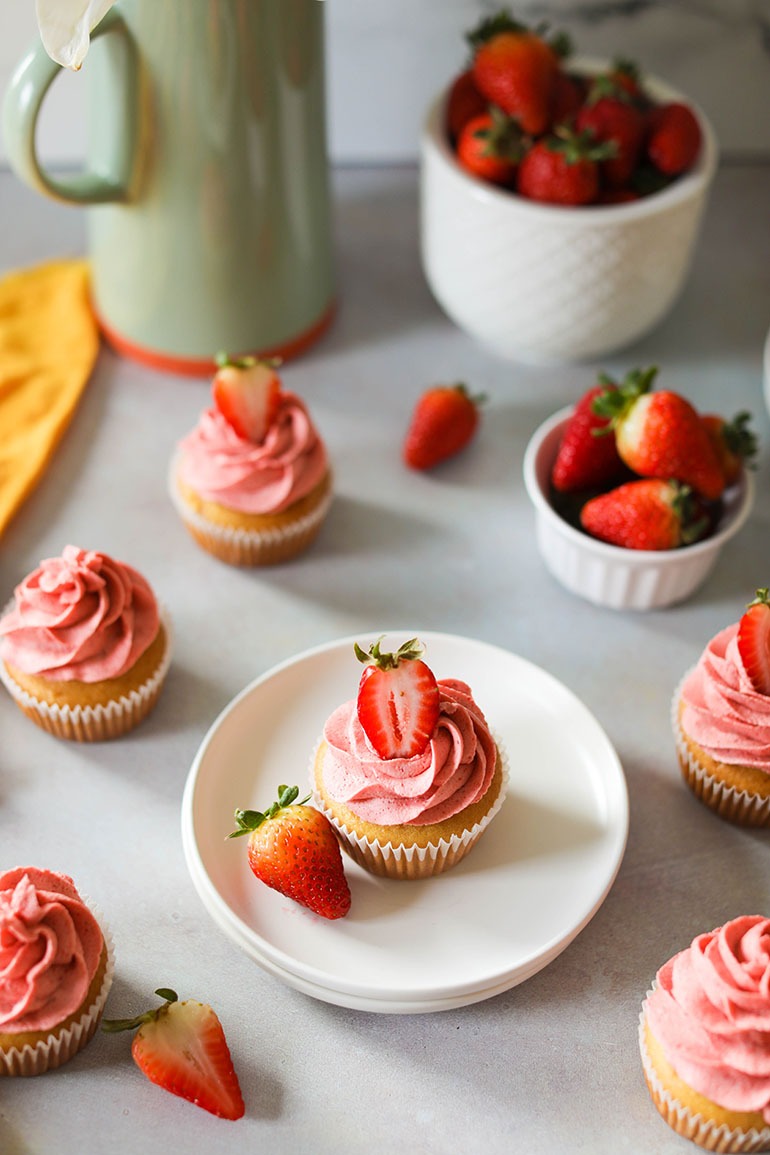 Vegan Strawberry Cupcakes on white plate with fresh strawberries