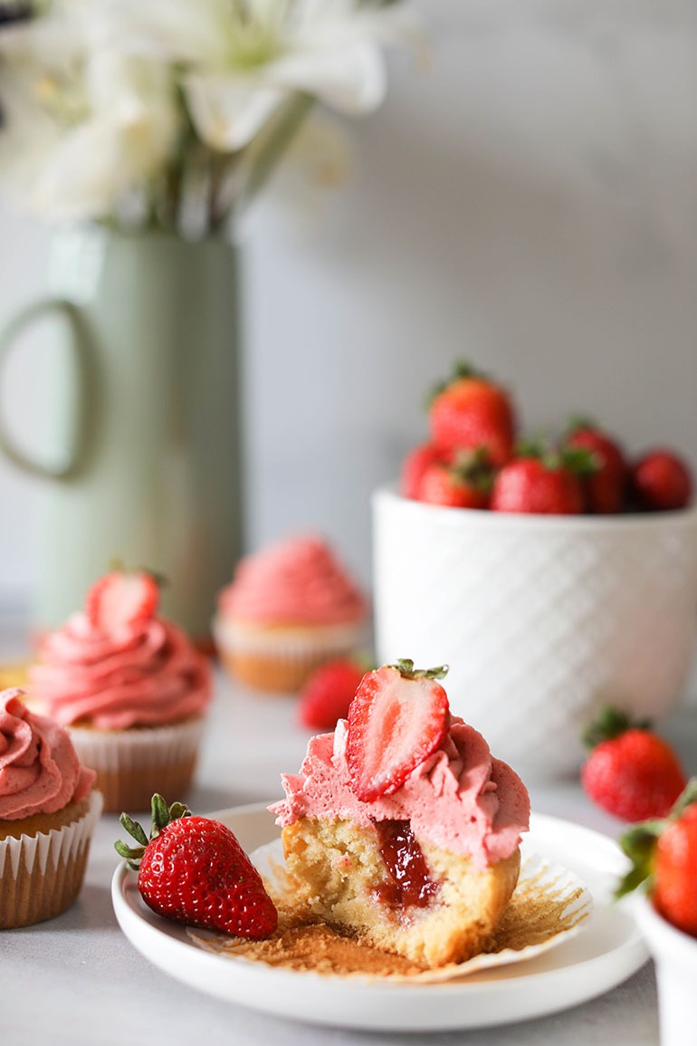 Vegan Strawberry Cupcake with strawberry filling on white plate