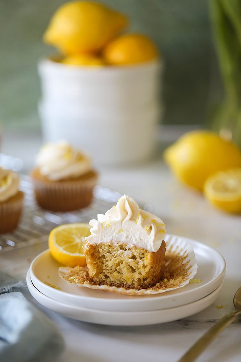 Vegan Lemon Cupcakes on small white plate cut in half