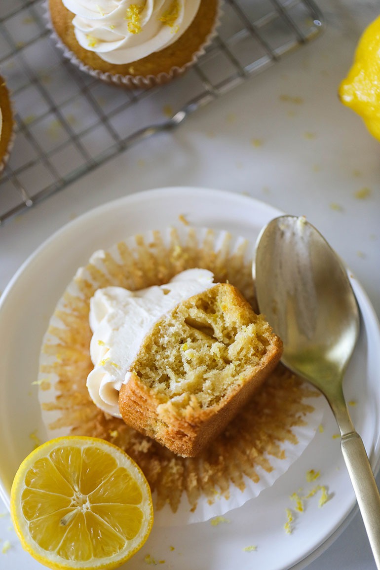Vegan Lemon Cupcake on small white plate facing up cut in half