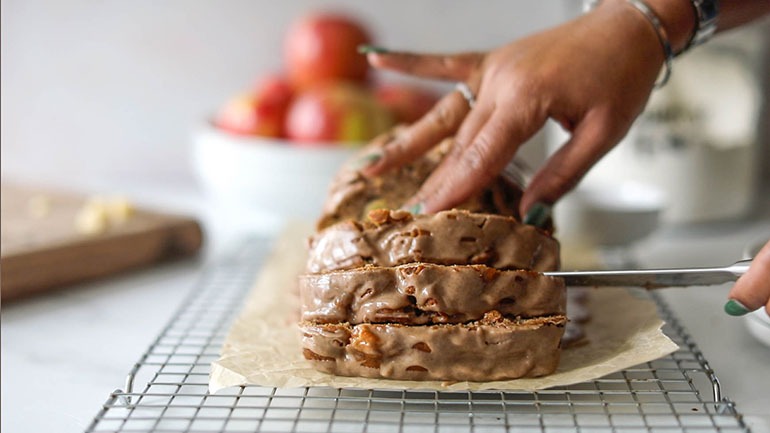 Vegan Cinnamon Apple Bread with brown hand