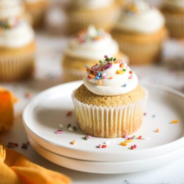 Vegan Vanilla Cupcakes with sprinkles on white plate