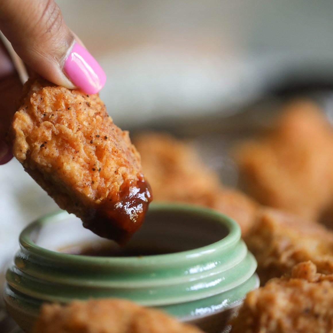 Spicy Chicken Fried Tofu dipping in sauce