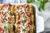 Vegan Spinach Lasagna Rolls with Almond Ricotta in white square baking dish
