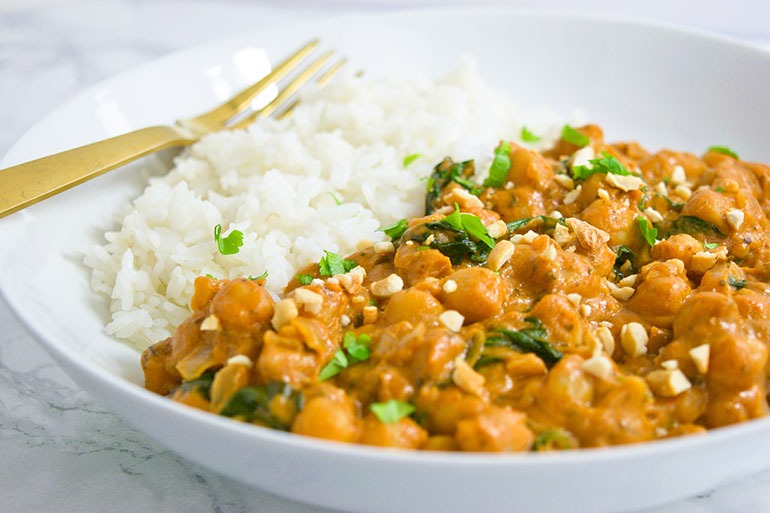 Chickpea Peanut Stew in white bowl with rice