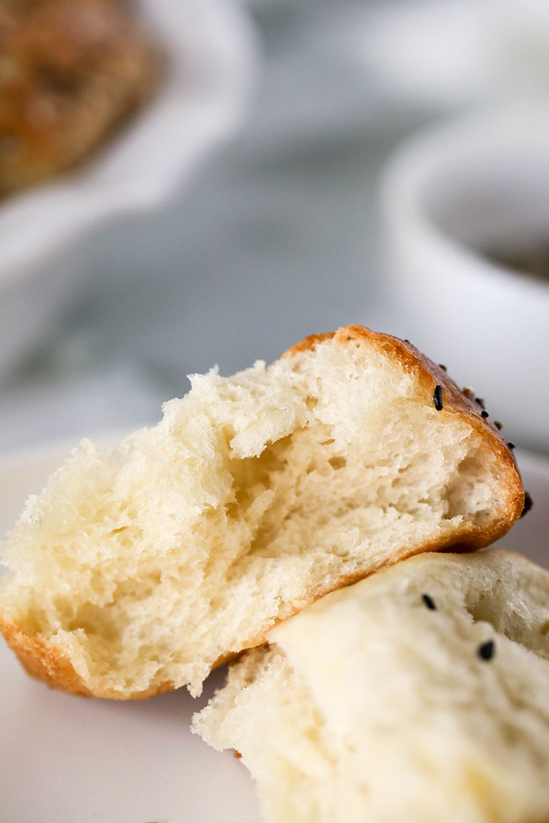 Vegan Everything Bagel Seasoning Dinner Roll broken apart