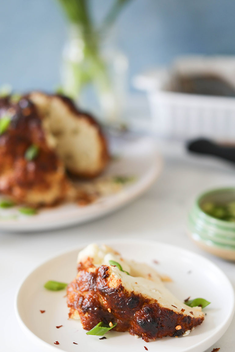 Sliced Spicy Roasted Cauliflower Head on white plate