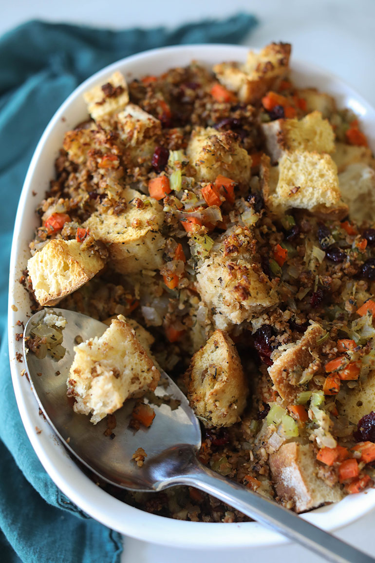 Vegan Sausage Stuffing in white serving dish