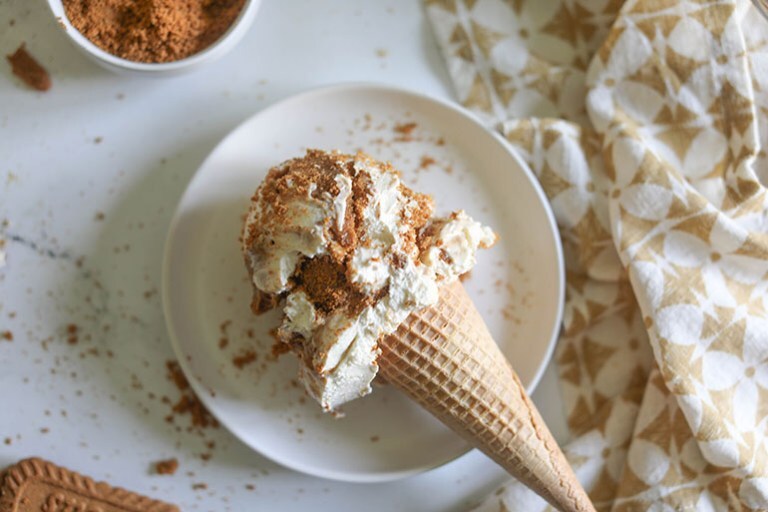 Vegan Cookie Butter Ice Cream in a cone on a plate