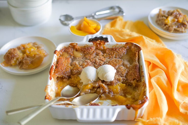 Easy Vegan Peach Cobbler in a white dish