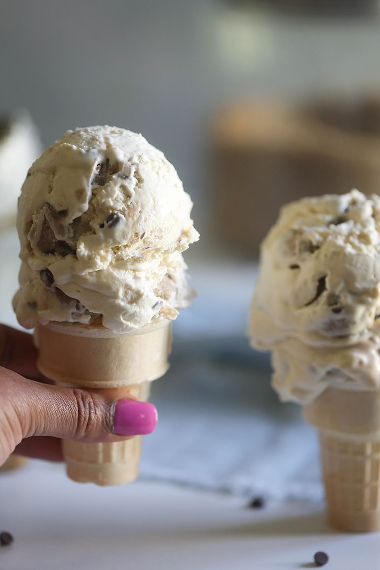 Vegan Chocolate Chip Cookie Dough Ice Cream on a cone in brown hand